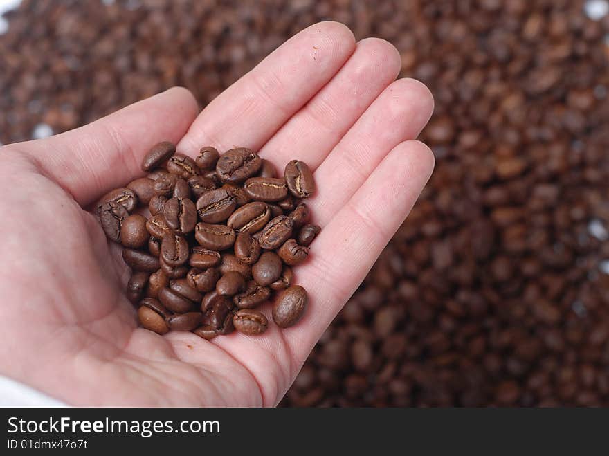 Hand of man and coffee beans