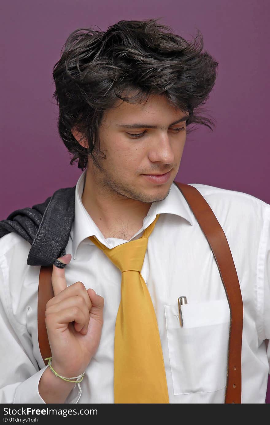 Young man posing against a purple background