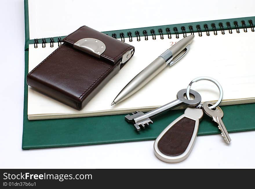 Diary,handle and keys on a white background. Diary,handle and keys on a white background