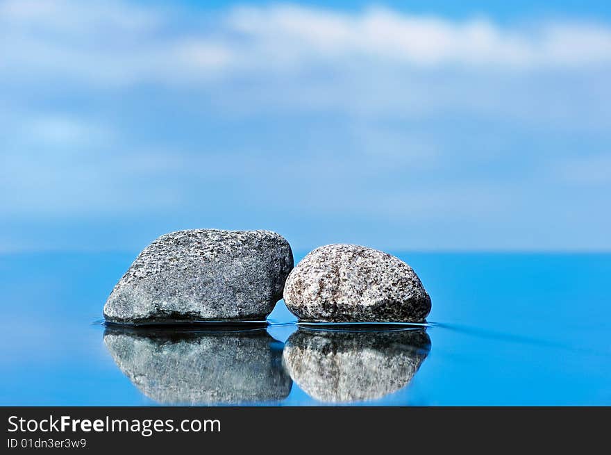 Stones on a smooth surface against the dark blue sky. Stones on a smooth surface against the dark blue sky