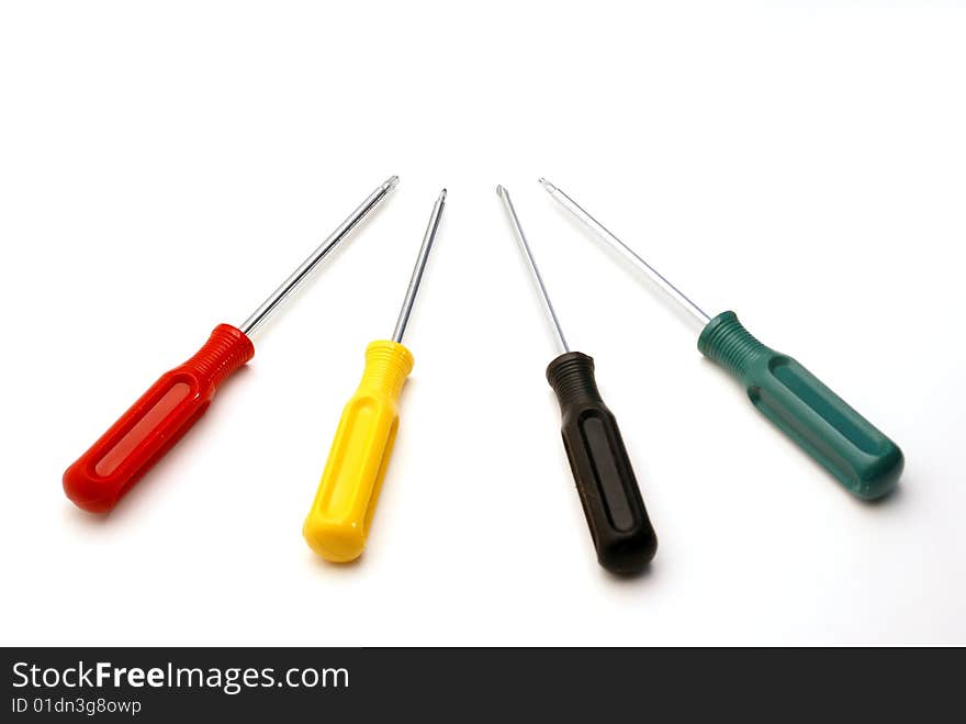 Four colored screwdrivers are isolated over white.
