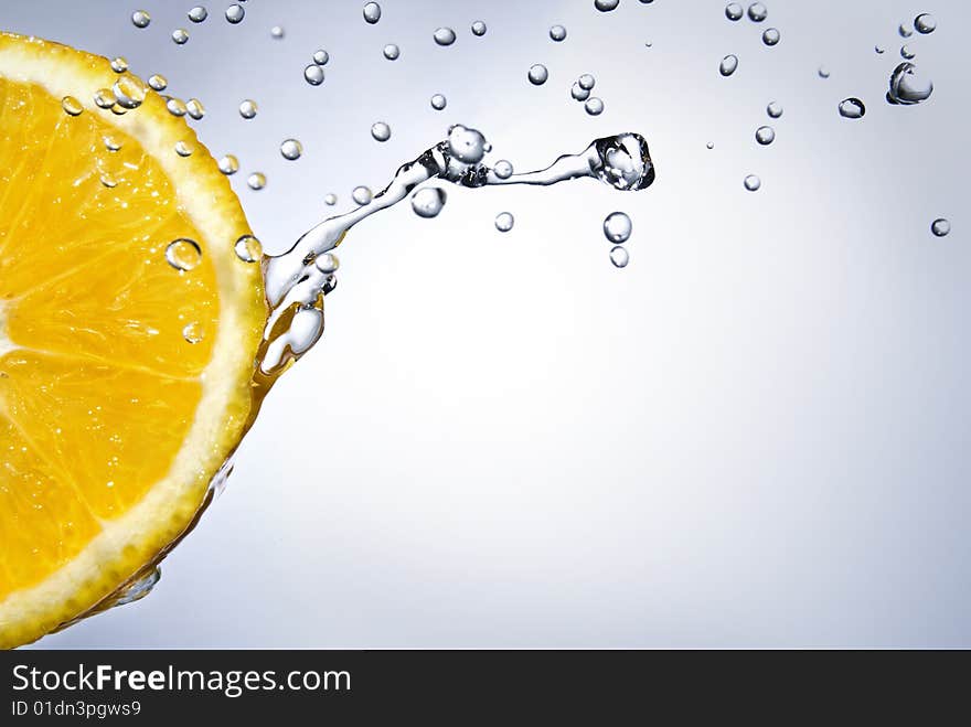 Fresh water drops on orange