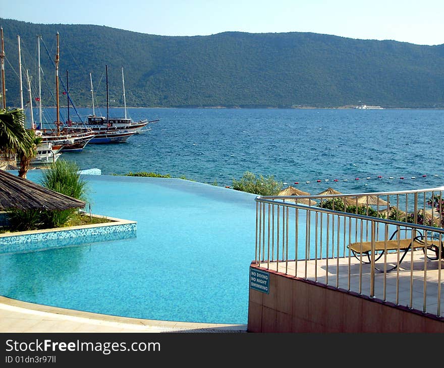 Blue Pool And Seaside As Background