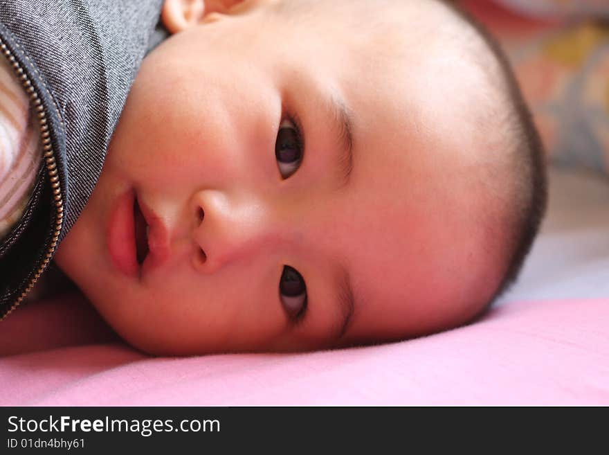 Cute, happy laughing baby boy in the morning.