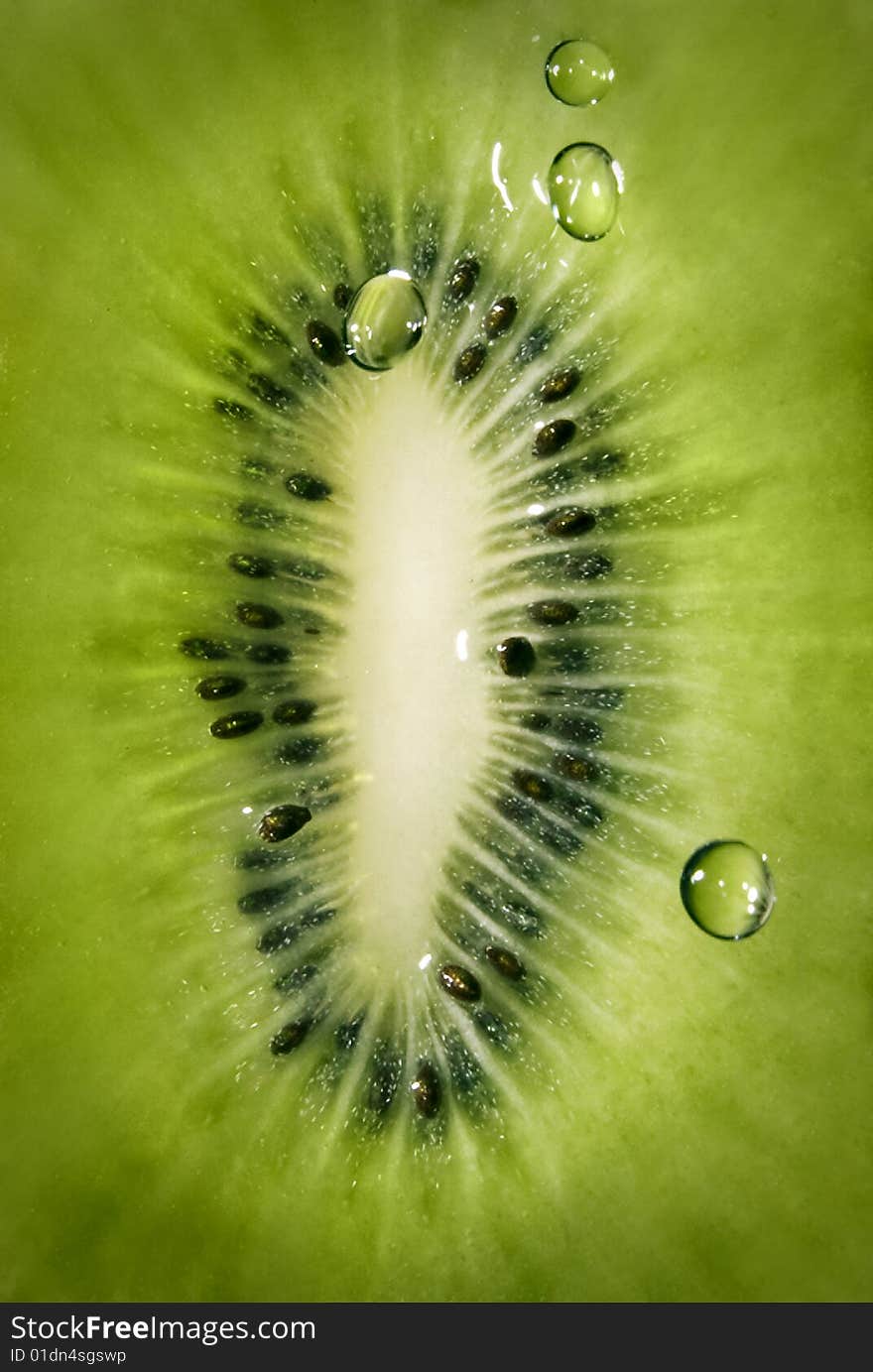 Macro of kiwi with water drops background