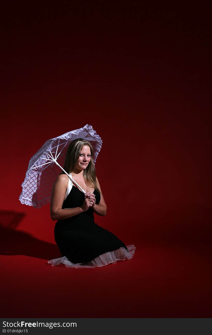 Pretty woman with lace parasol against red background. Pretty woman with lace parasol against red background