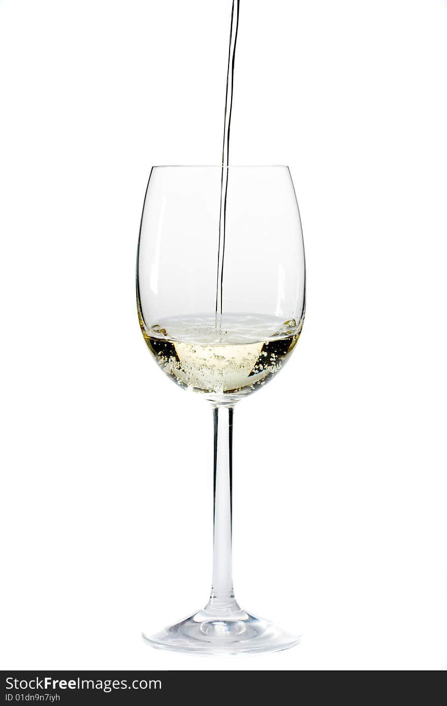 Pouring white wine in a glass over a white background