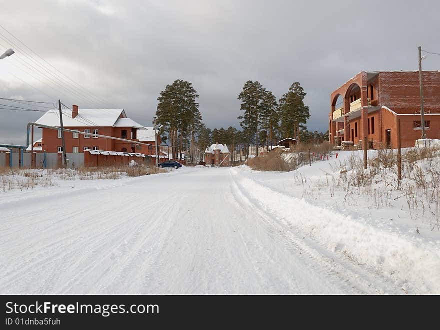 Village street, unfinished house without roof