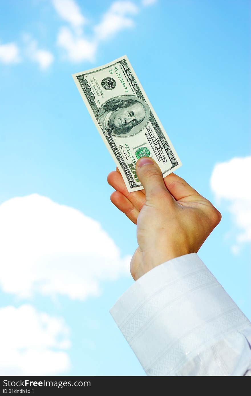 Money in hand  isolated on sky background