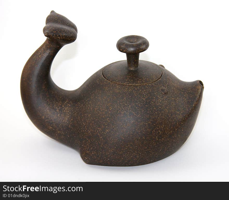 A red clay teapot with a mottled pattern crafted in the Yixing region of China in the shape of a baleen whale. A red clay teapot with a mottled pattern crafted in the Yixing region of China in the shape of a baleen whale.