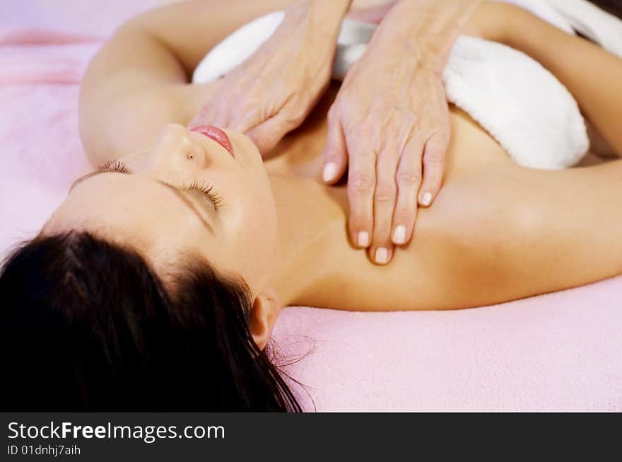 Young woman lying and getting massage on her shoulders. Young woman lying and getting massage on her shoulders