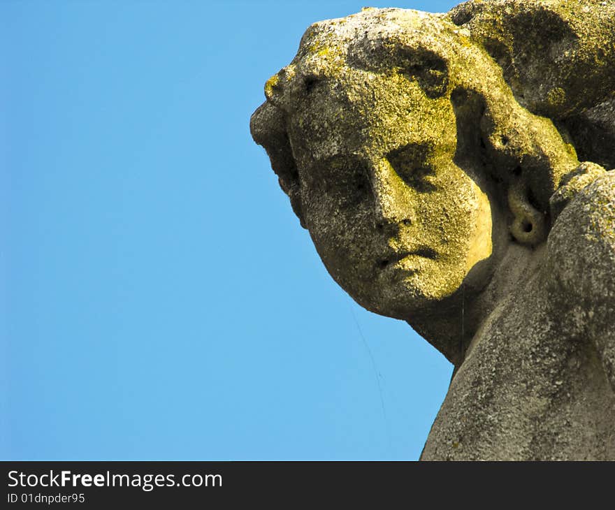 A gorgeous statue covered with moss from aging. A gorgeous statue covered with moss from aging