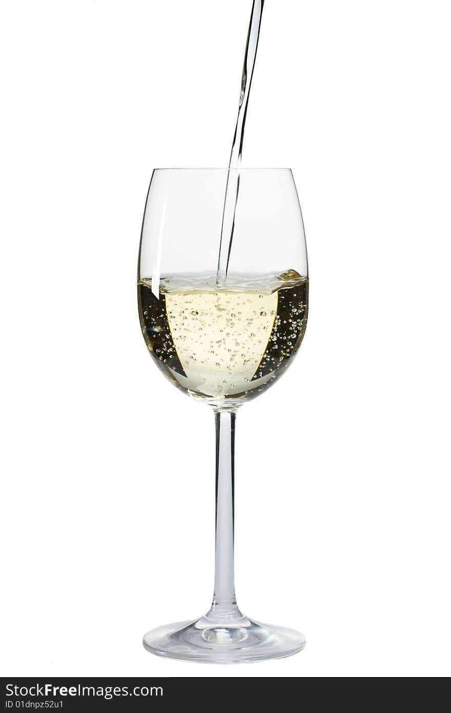 Pouring white wine in a glass over a white background