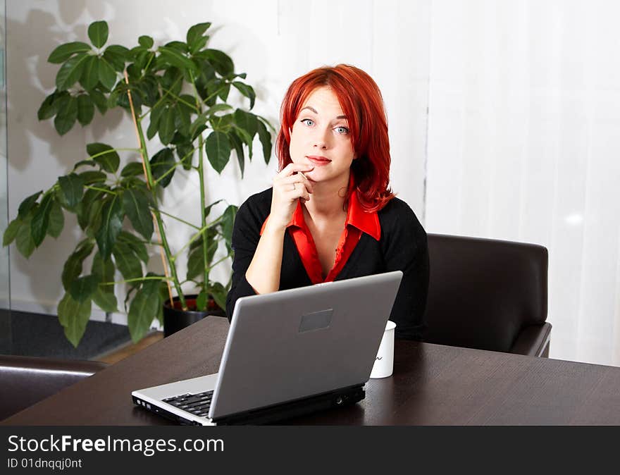 Young pretty caucasian businesswoman in the office. Young pretty caucasian businesswoman in the office