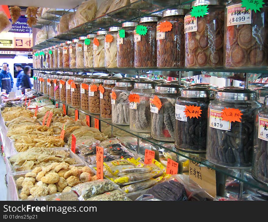 Chinatown market with rows of bottled good and fish bladders