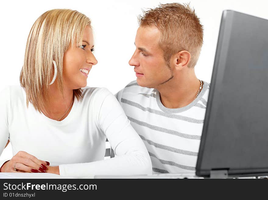 Portrait of a happy couple working with laptop in home or office. Portrait of a happy couple working with laptop in home or office