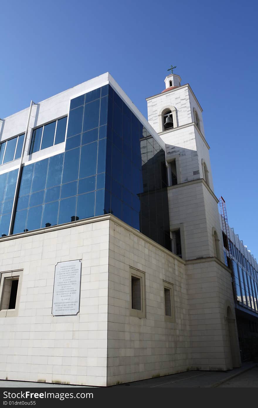 Bellfry on a glass windowed modern college