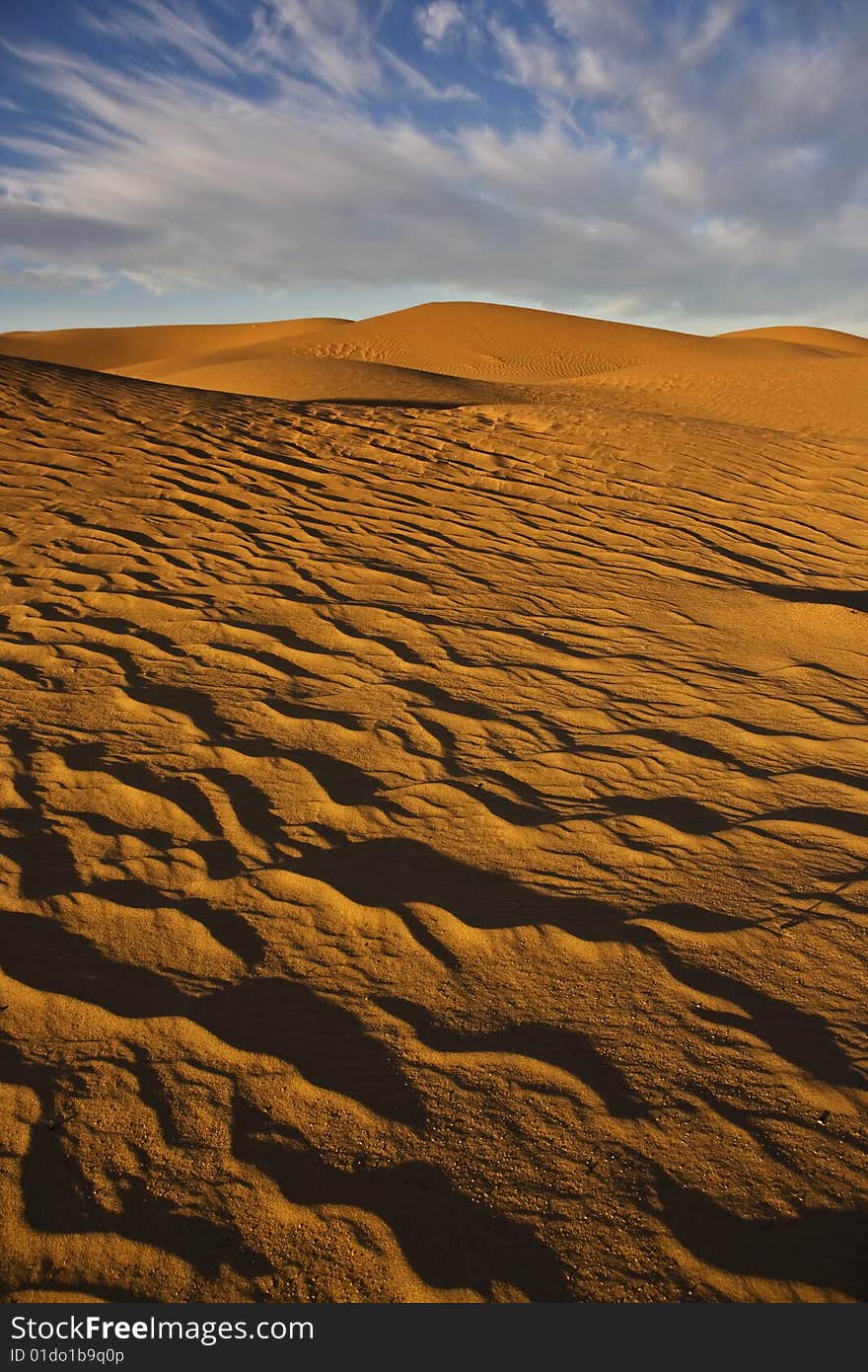 Sand dunes with cloudy sky