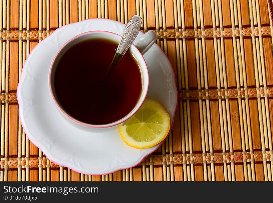 Cup of black tea with lemon