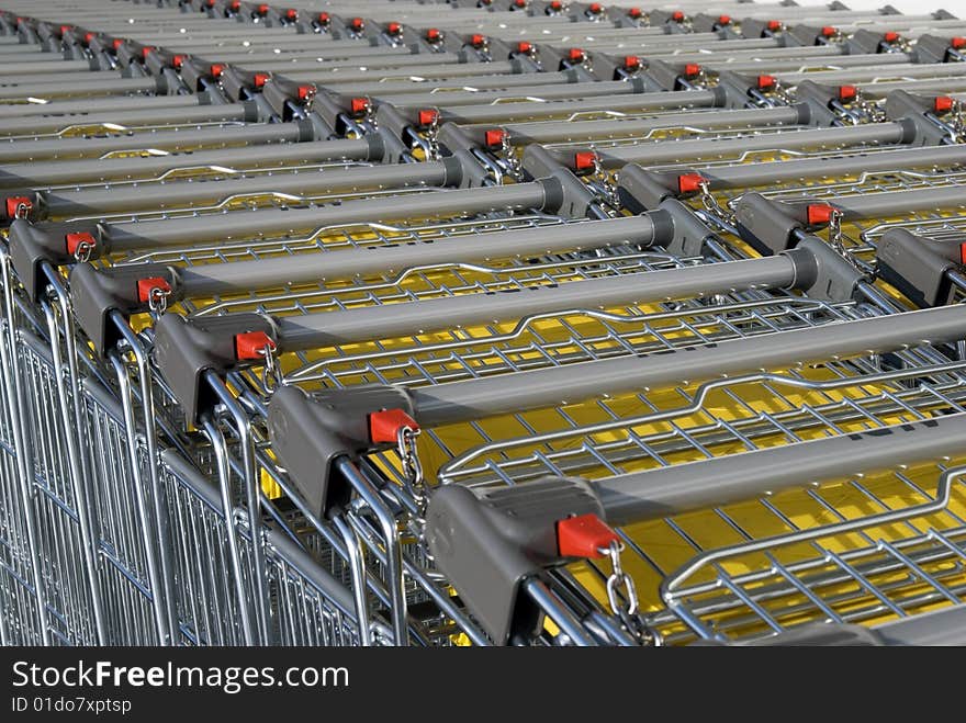 Stacked shopping carts at supermarket. Stacked shopping carts at supermarket.