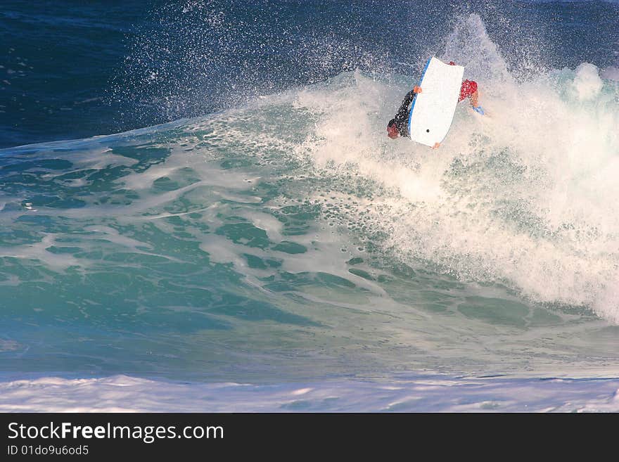 A bodyboarder catches air at the world famous Bonzai Pipline wave on the North Shore of Oahu Hawaii and does an ARS. A bodyboarder catches air at the world famous Bonzai Pipline wave on the North Shore of Oahu Hawaii and does an ARS.