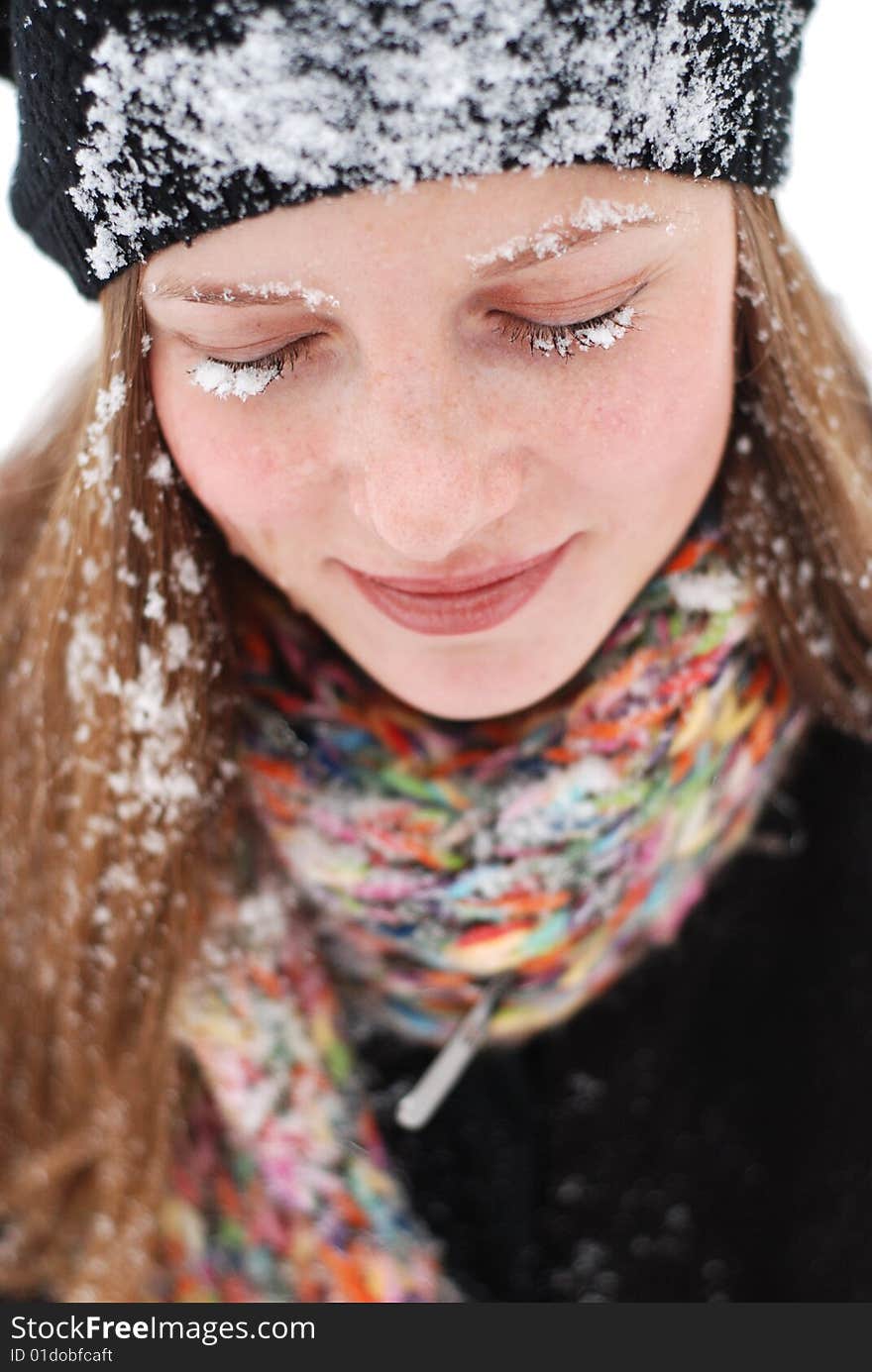 Beautiful young woman with snow on her clothes. Beautiful young woman with snow on her clothes