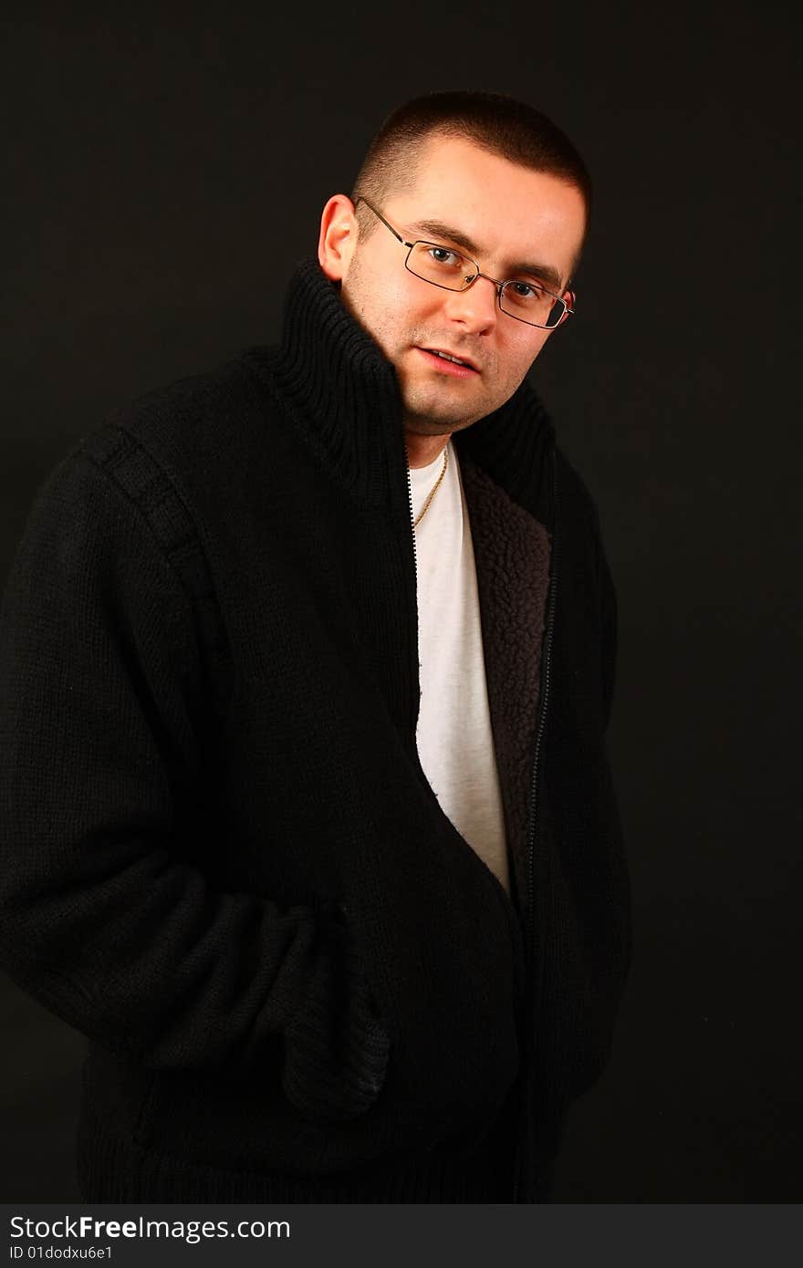 Young relaxed casual man on the dark background