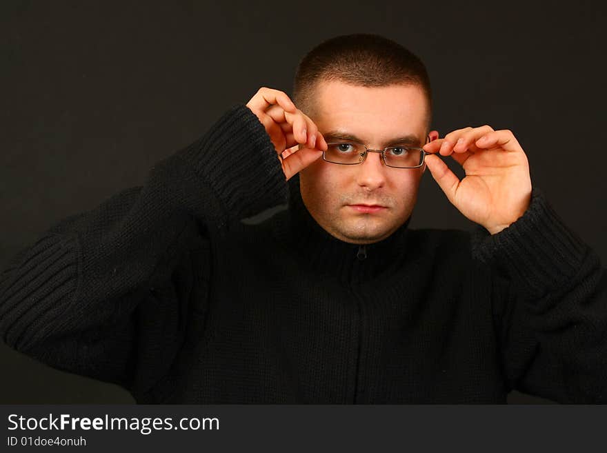 Young relaxed casual man on the dark background. Face portrait. Young relaxed casual man on the dark background. Face portrait