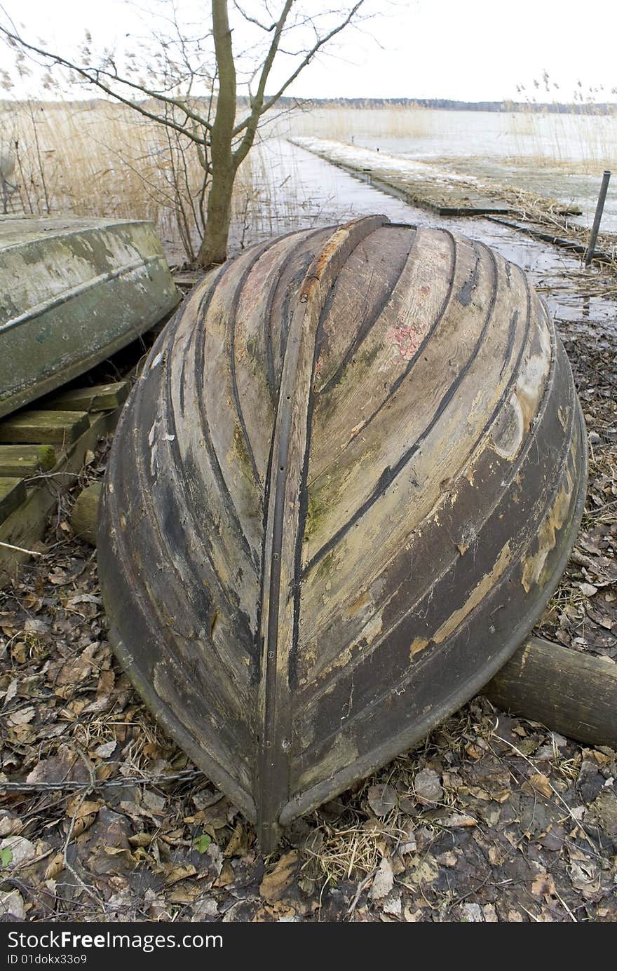 Wooden rowing boat up-side-down.