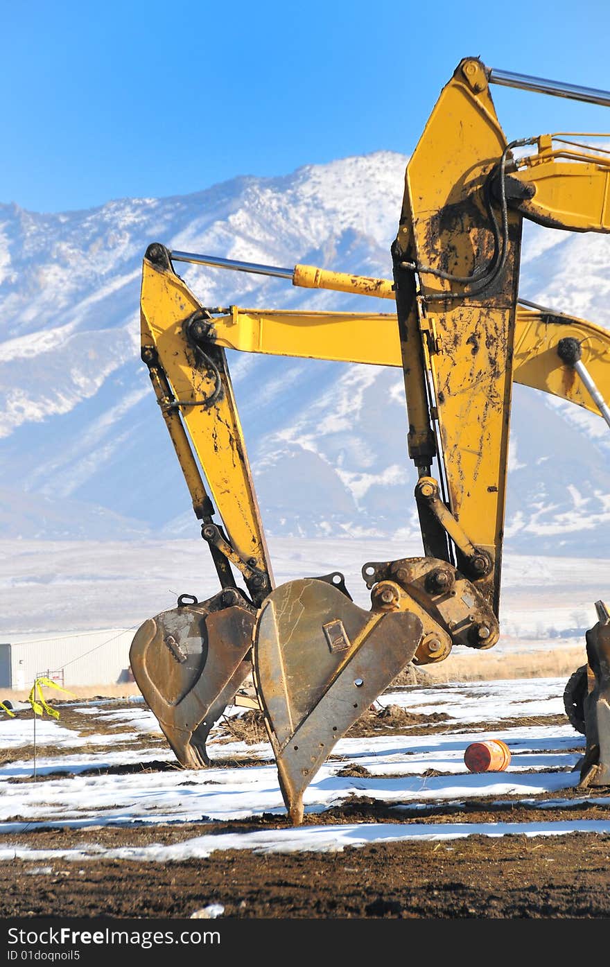 Side by side bull dozers digging in the dirt. Side by side bull dozers digging in the dirt