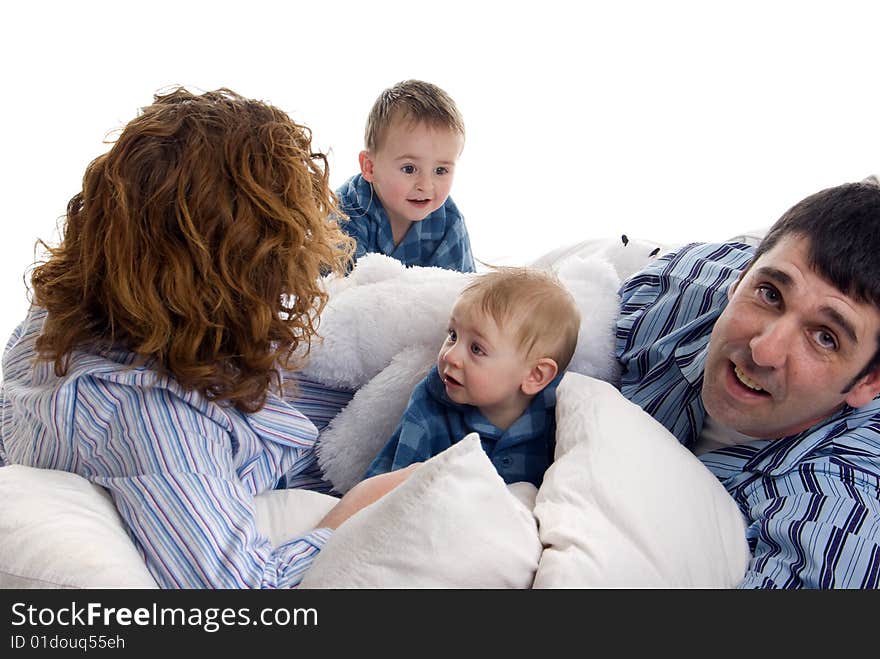 Family of four wakes up and relaxes in bed. Family of four wakes up and relaxes in bed