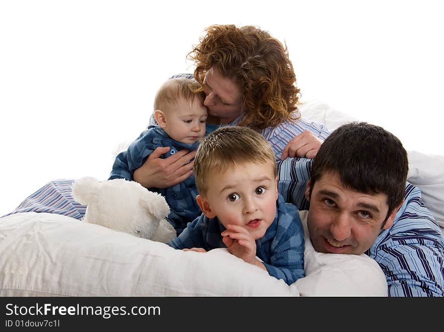 Family of four wakes up and relaxes in bed. Family of four wakes up and relaxes in bed