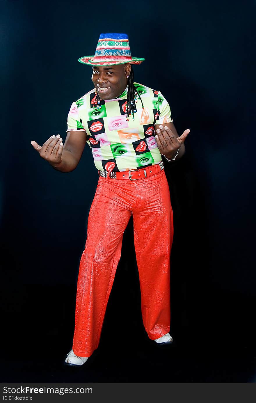 Young smiling black man invites everybody, on black background. Young smiling black man invites everybody, on black background