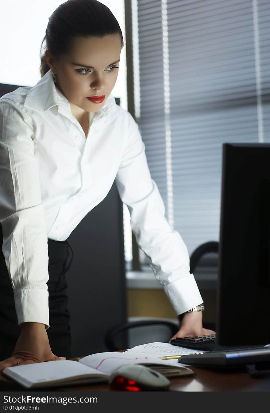 Beautiful girl in the evening in office. Beautiful girl in the evening in office