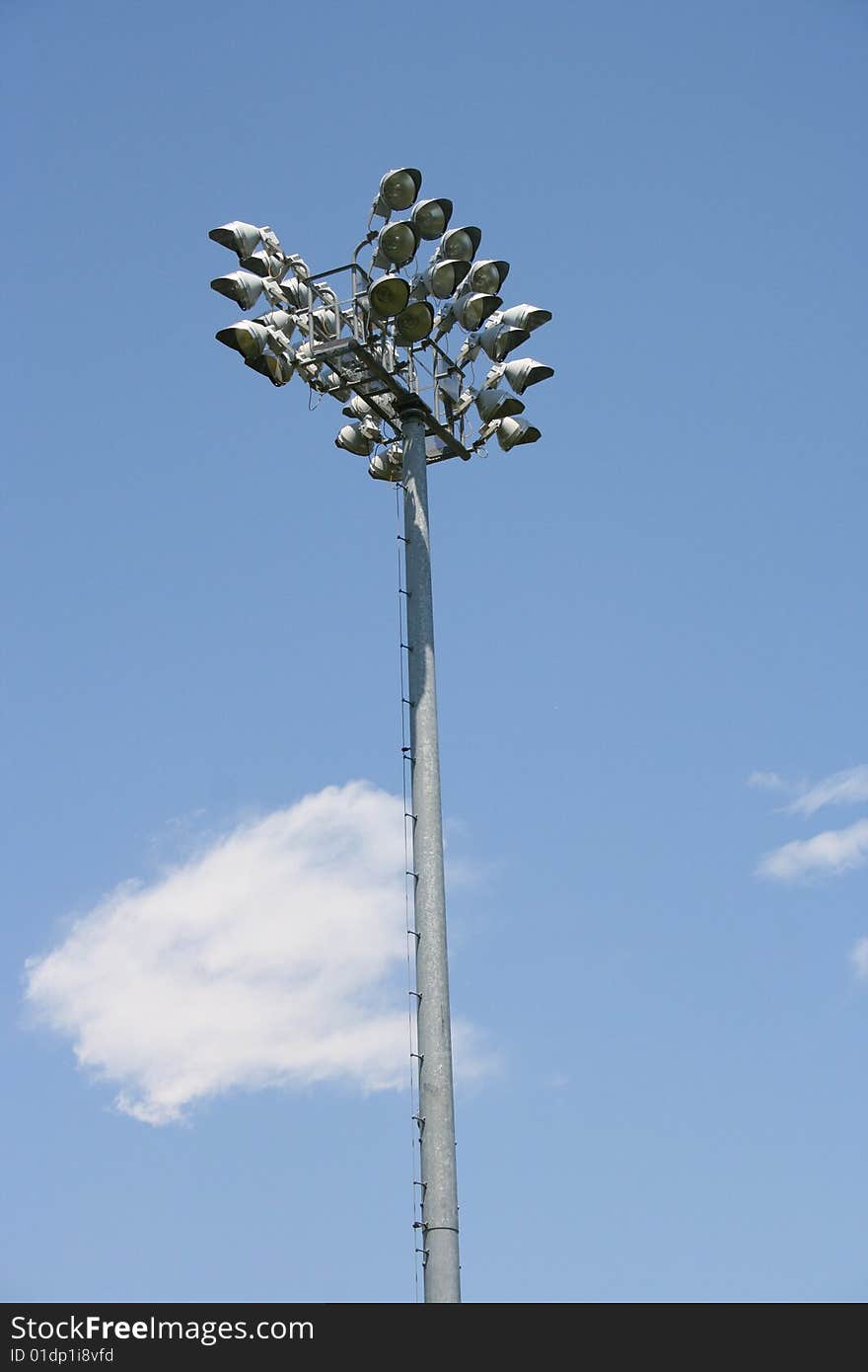 Stadium-style lights, taken at sports fields at a park, looking up, clear blue sky background, daytime so the lights are off. Stadium-style lights, taken at sports fields at a park, looking up, clear blue sky background, daytime so the lights are off.