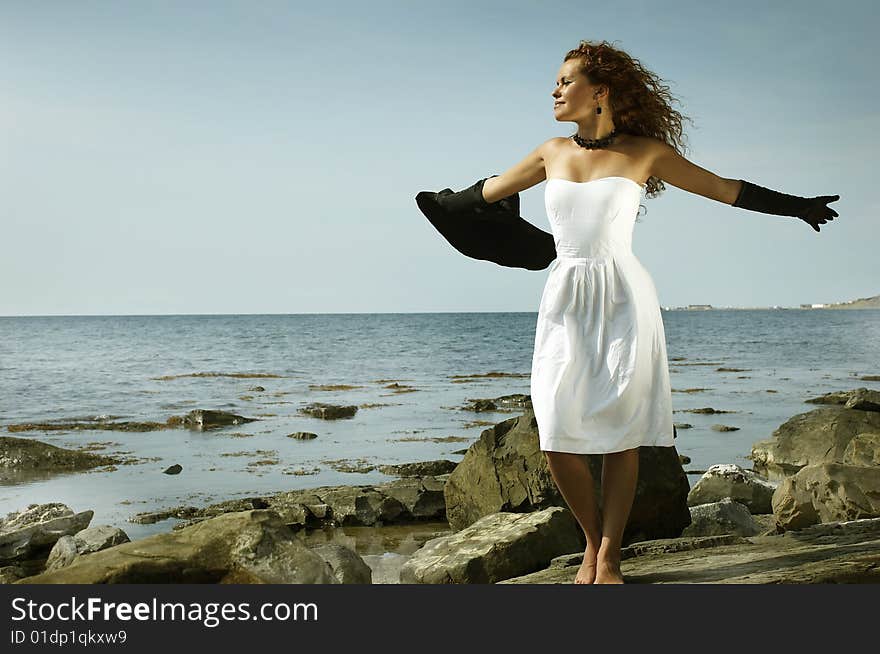 Sexual girl вбелом a dress on a sea beach