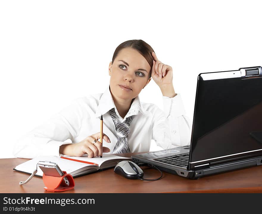 The beautiful business woman sits at a working table. The beautiful business woman sits at a working table