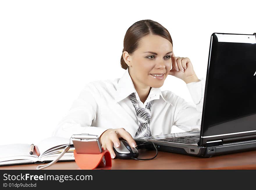 The beautiful business woman sits at a workplace. The beautiful business woman sits at a workplace