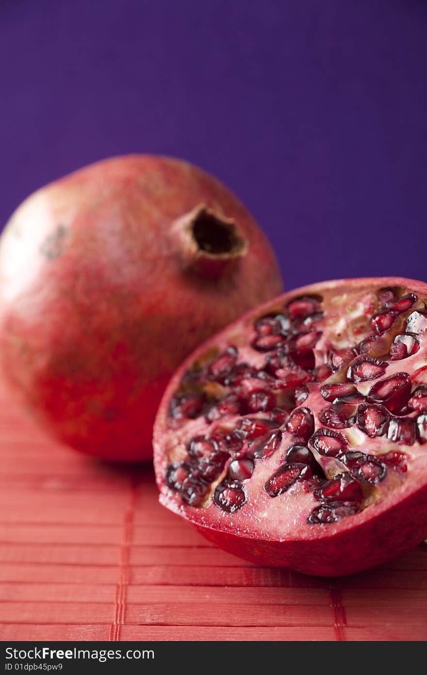 Fresh pomegranate halves, tropical fruit