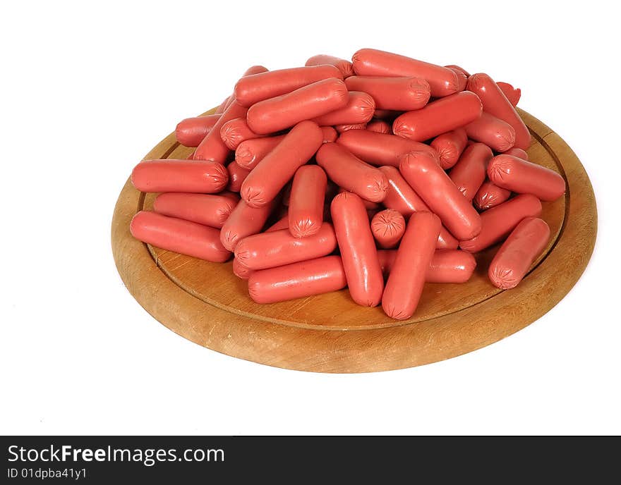 Fresh sausages on wood plate