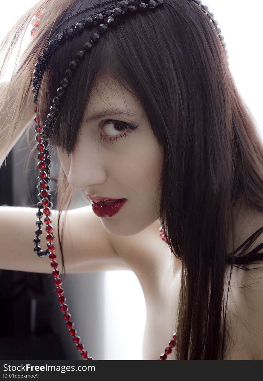 Beautiful girl with beads portrait photo