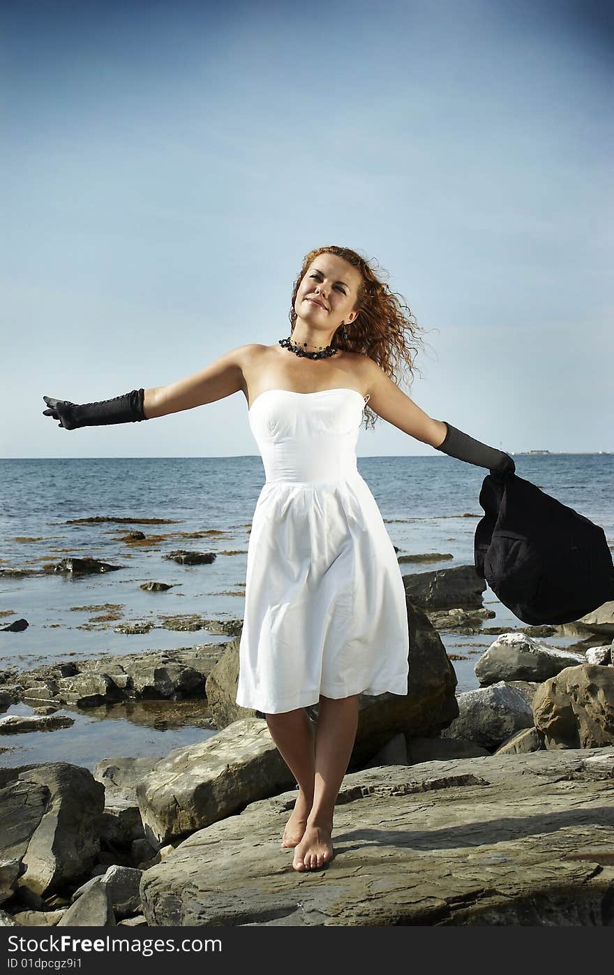 Girl In A Hat On A Coast Of The Sea