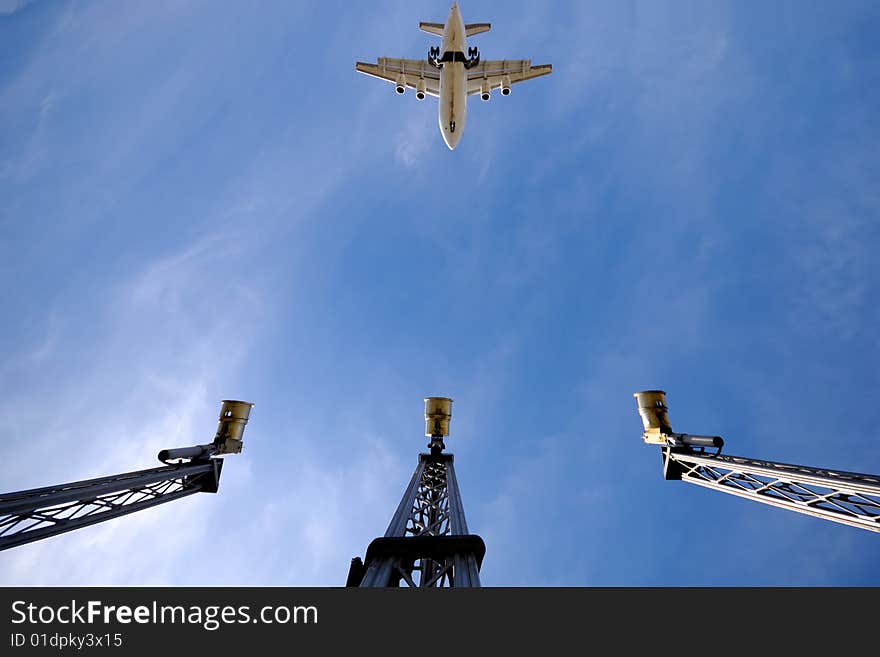 A plane is flying over landing lights in airport. Note the plane is in motion blur and not in focus. A plane is flying over landing lights in airport. Note the plane is in motion blur and not in focus.