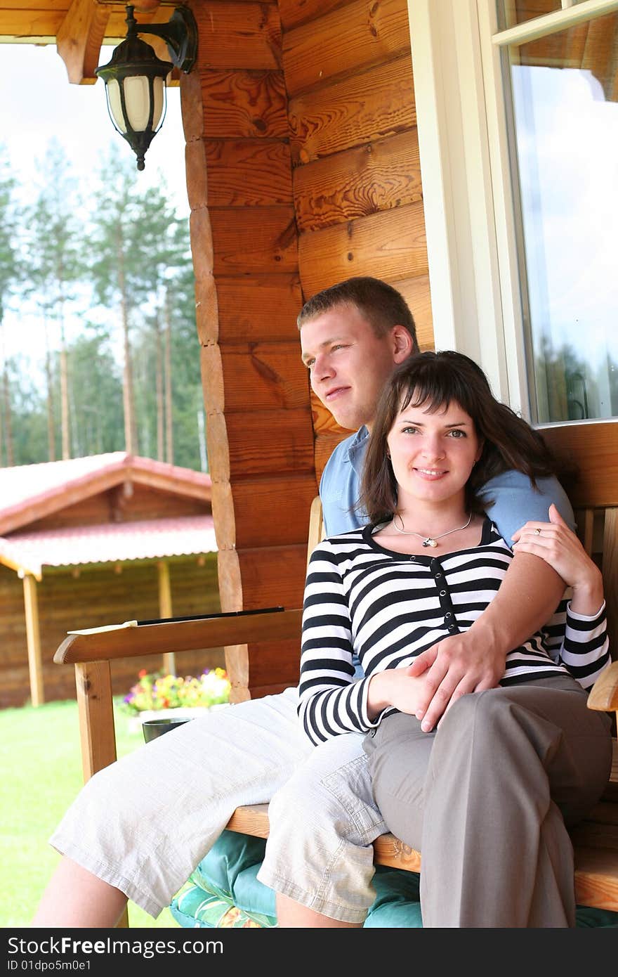 Couple Relaxing On Verandah