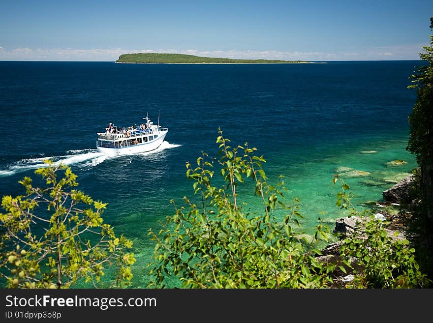 Tour boat cruising around an Island. Tour boat cruising around an Island