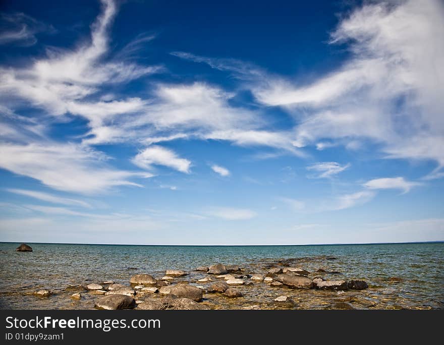 Open blue sky over rocky beach. Open blue sky over rocky beach