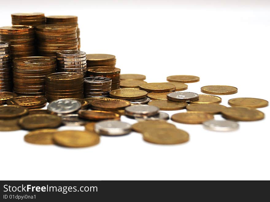 Different coins stacked on white background