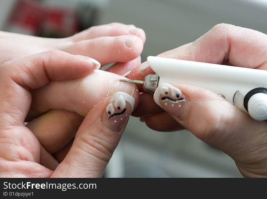 Foot therapist working on a girls nails. Foot therapist working on a girls nails