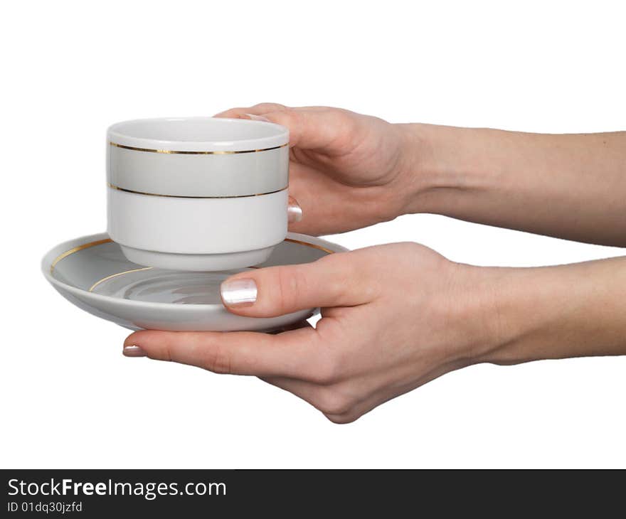 Cup and saucer in female hands on the isolated