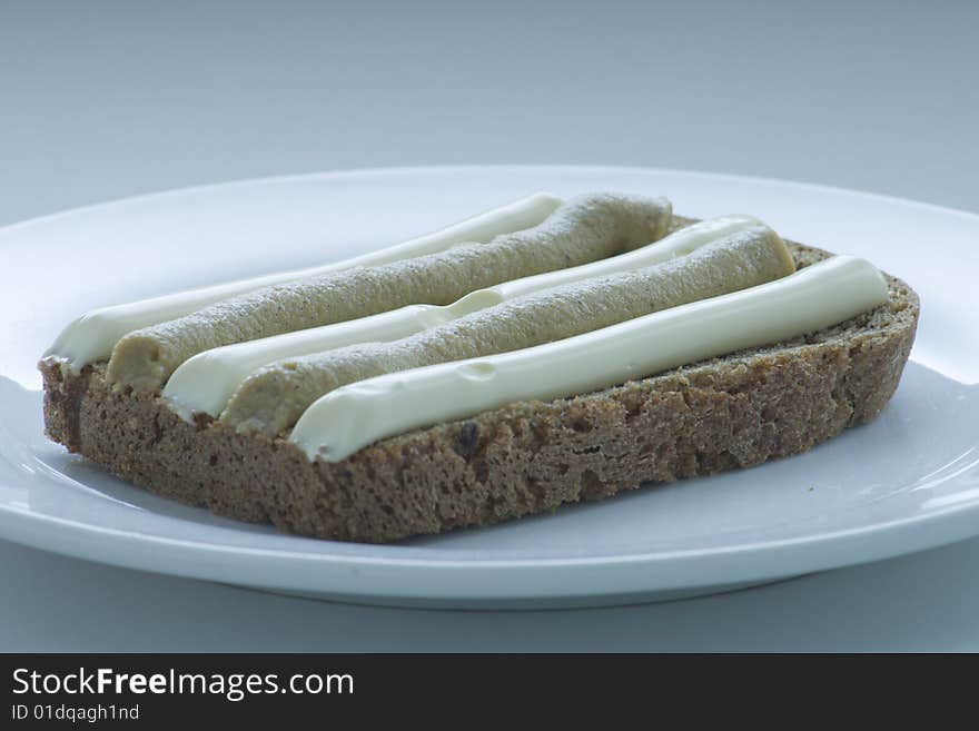 Black bread with mayonnaise and mustard on a plate. Black bread with mayonnaise and mustard on a plate